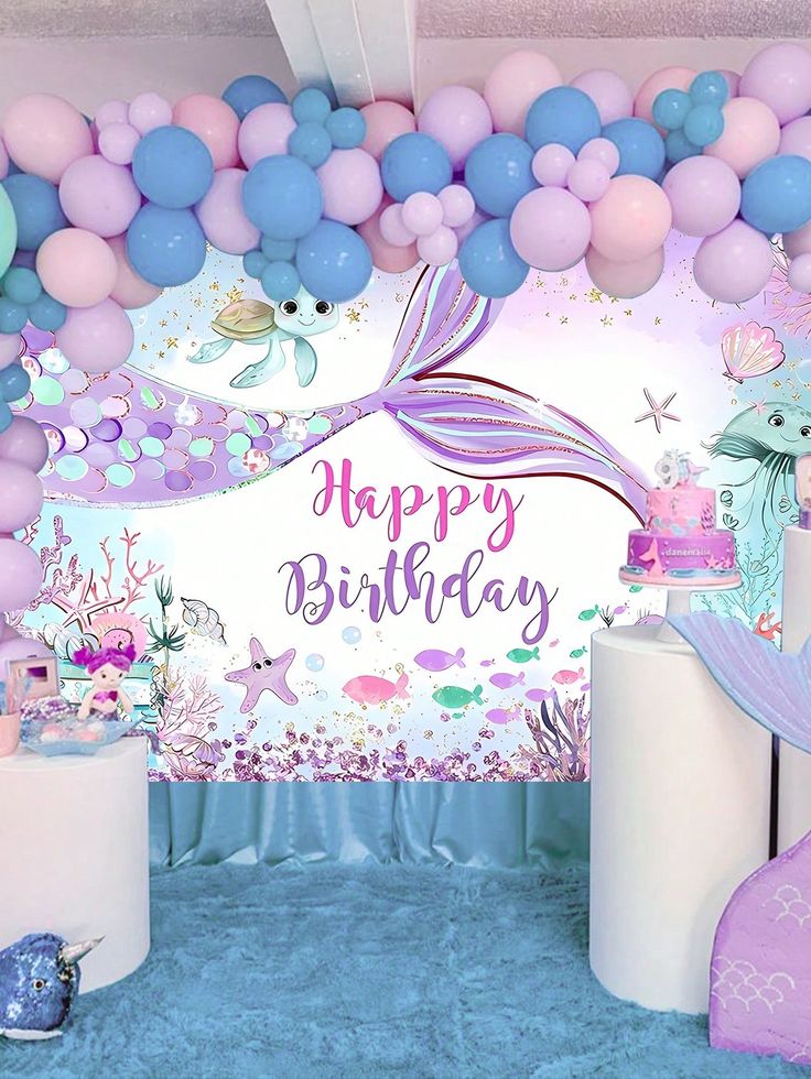 a mermaid themed birthday party with balloons and decorations