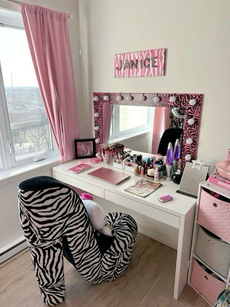 a zebra print chair sitting in front of a desk with a mirror and makeup on it