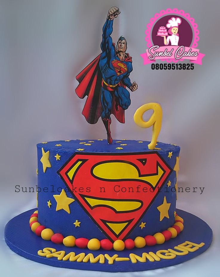 a superman birthday cake with the number 9 on it and an image of a super hero