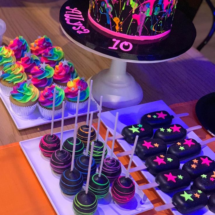 a table topped with lots of cupcakes and cake