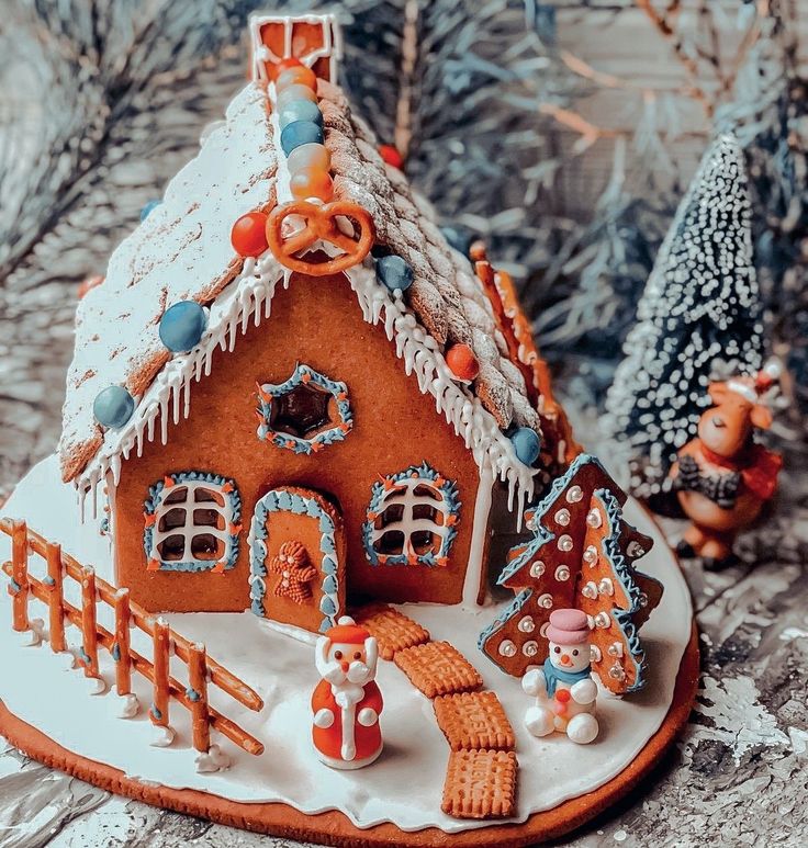 a gingerbread house decorated with icing and decorations