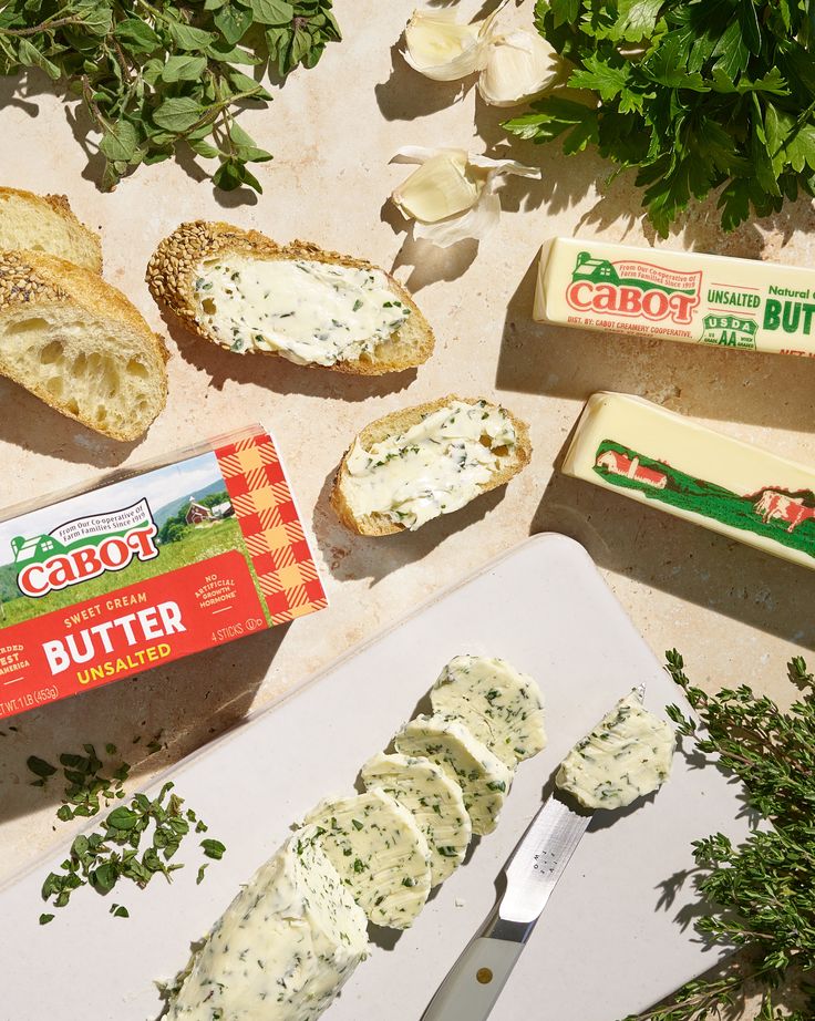 bread, butter and herbs on a cutting board