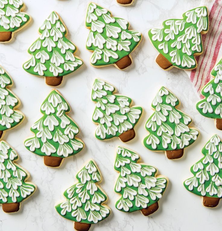 green and white decorated cookies with trees on them