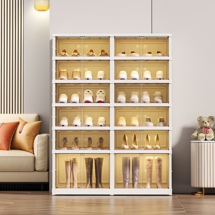 a room filled with lots of different types of women's shoes on shelves next to a couch