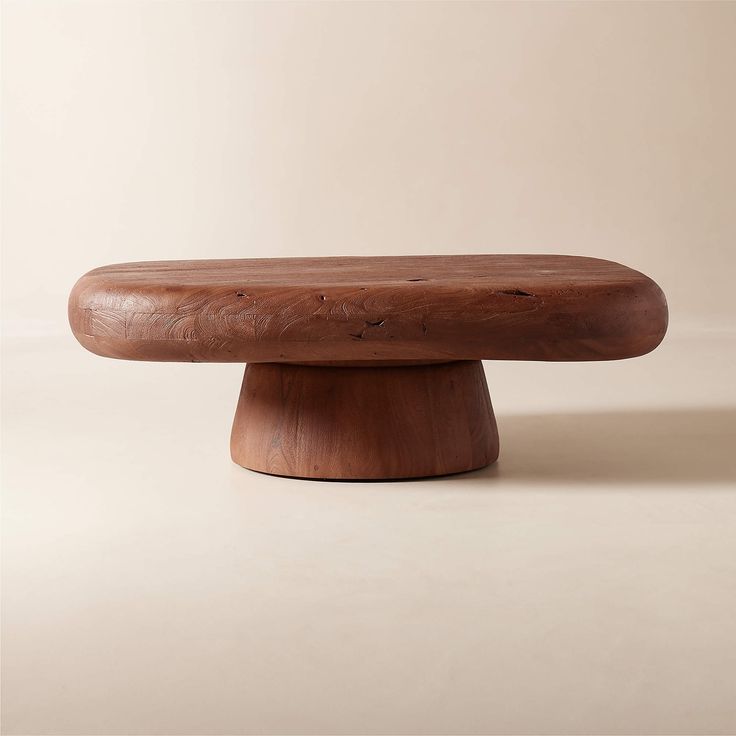 a wooden bench sitting on top of a white floor next to a beige wall with no one in it