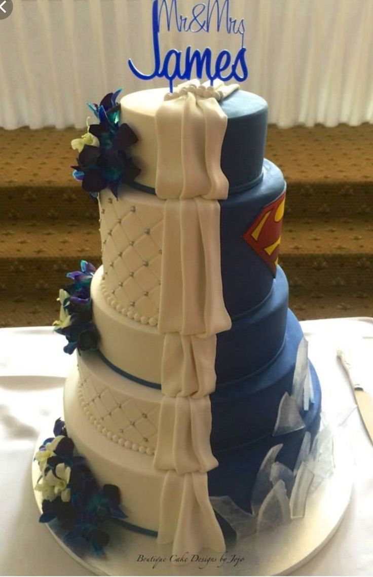 a wedding cake is decorated with blue and white ribbons