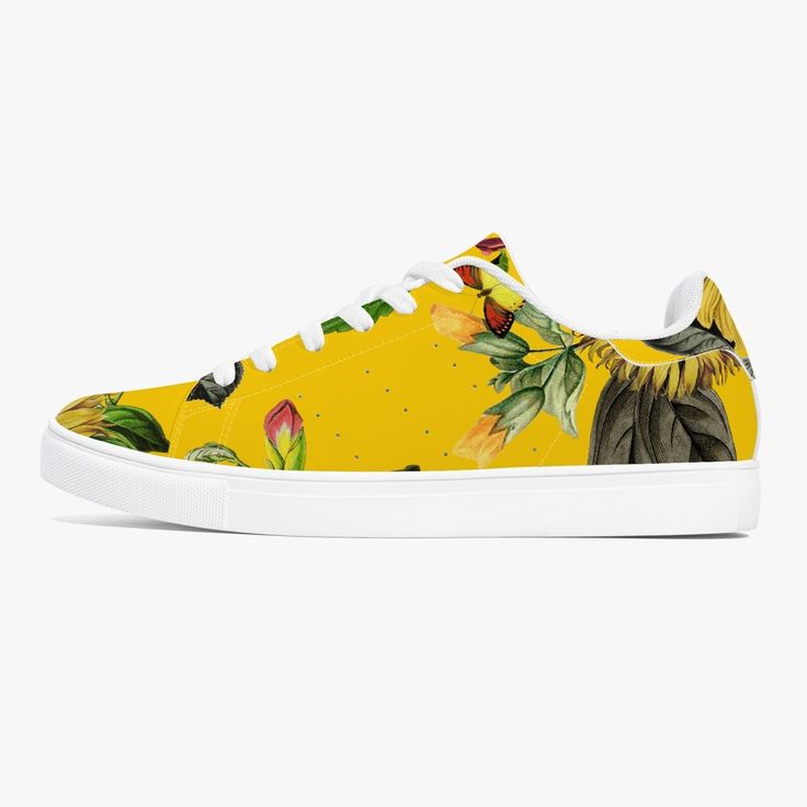 Step into style and comfort with Jacki Easlick Sunflowers Low-Top Leather Sneakers. Featuring a vibrant sunflower design on genuine leather, these sneakers will keep you light on your feet while adding a splash of playful charm to any outfit. All-over-print leather upper with mesh lining Comes in White or Black soles Soft EVA padded insoles Classic eyelets and lace-up closure design Unisex Spring Leather Canvas Shoes For Streetwear, Spring Streetwear Leather Canvas Shoes, Sporty Floral Print Sneakers With Round Toe, Casual Lace-up Sneakers With Floral Print, Casual Floral Print Lace-up Sneakers, Summer Custom Low-top Sneakers With Rubber Sole, Yellow Summer Sneakers, Custom Low-top Summer Sneakers With Rubber Sole, Custom Low-top Sneakers With Rubber Sole For Summer