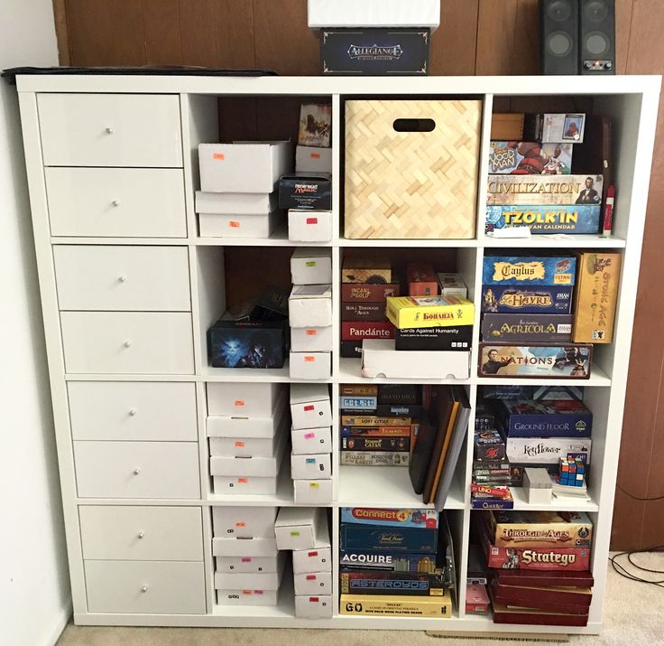 a white bookcase filled with lots of books