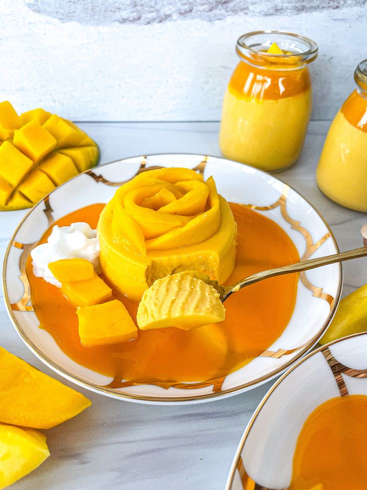 a white plate topped with sliced mango and caramel sauce