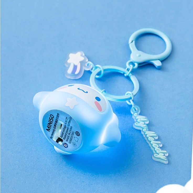 a blue light up keychain with a cartoon character on it