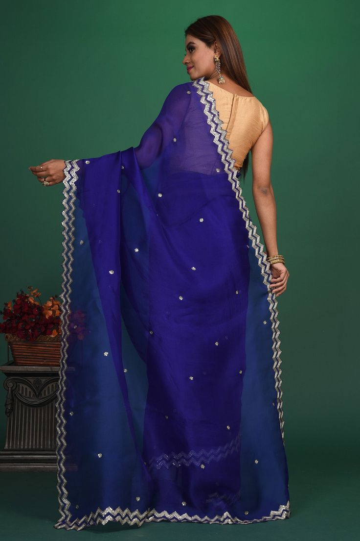 Be a vision of style and elegance at parties in this stunning royal blue embroidered organza saree. It comes with a matching blouse piece. Shop designer sarees online in USA from Pure Elegance. DISCLAIMER:- The shown stitched blouse on the model is for display purpose only. The saree comes with a matching blouse piece and finished with fall and piko.