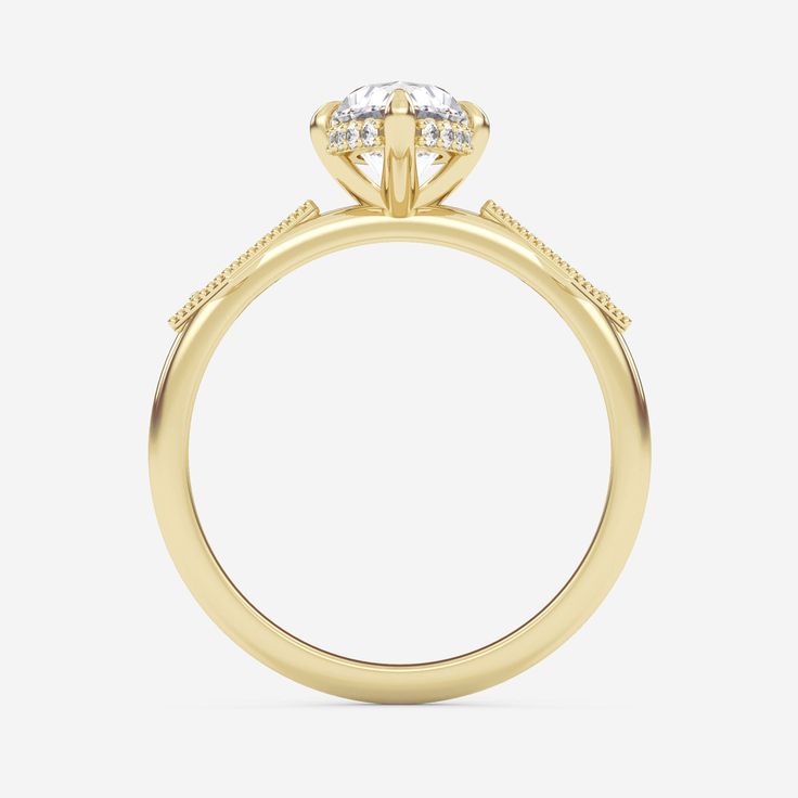 the side view of a yellow gold engagement ring with an oval cut diamond in the center