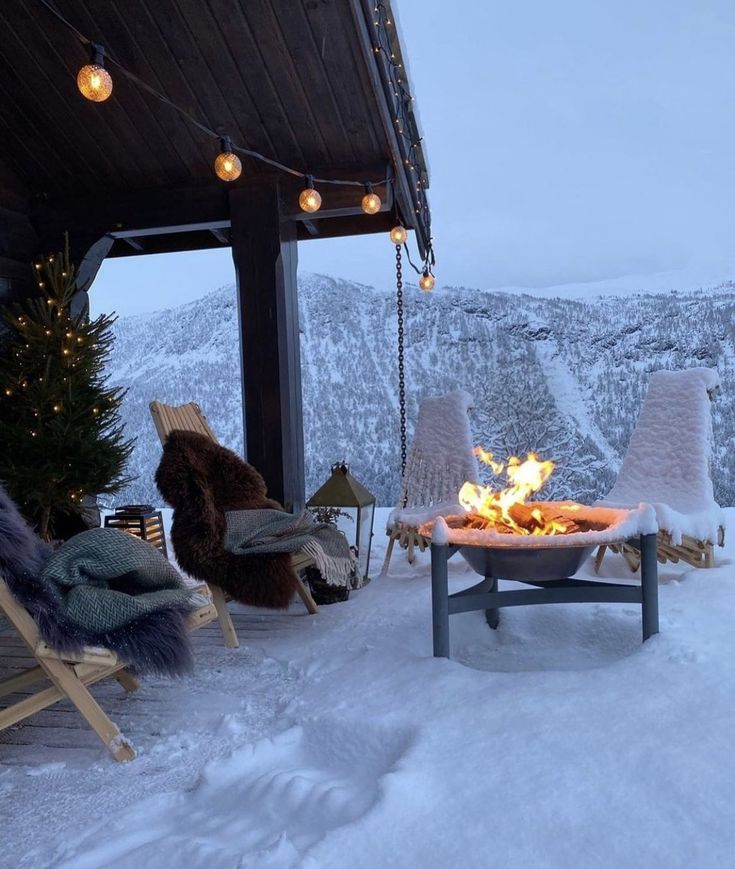 a fire pit sitting on top of a snow covered slope