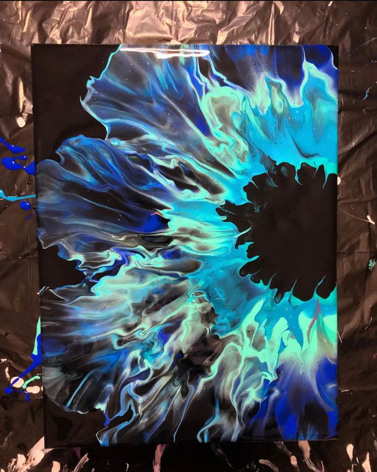 a blue and black painting on a piece of tin foil