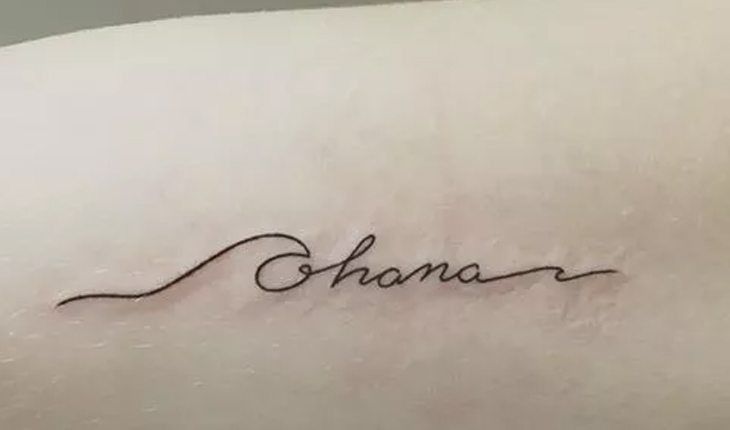 a woman's arm with the word ohana written in cursive writing