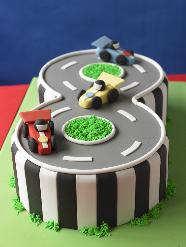 a birthday cake with cars driving on the road