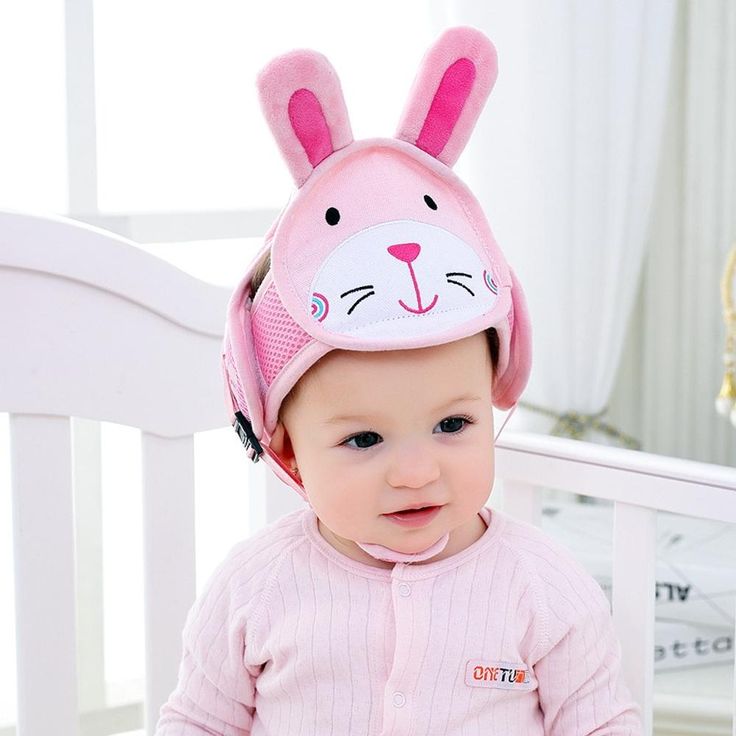 a baby wearing a pink bunny hat with ears