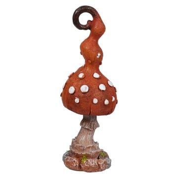 an orange and white mushroom statue with polka dots on it