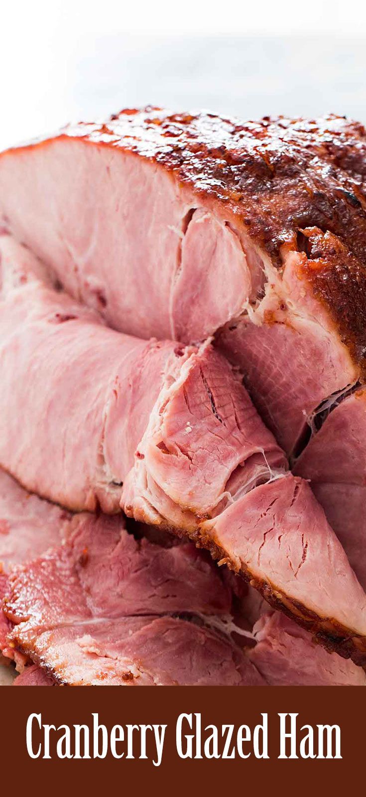 a close up of sliced ham on a plate with the words cranberry glazed ham