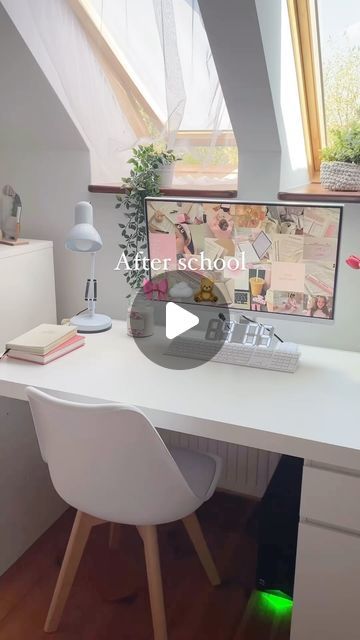 a white desk topped with a computer monitor next to a lamp and window sill