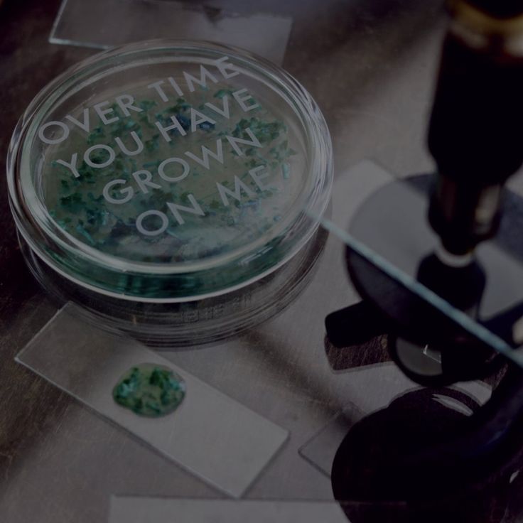 a glass jar with writing on it sitting on top of a table next to some scissors