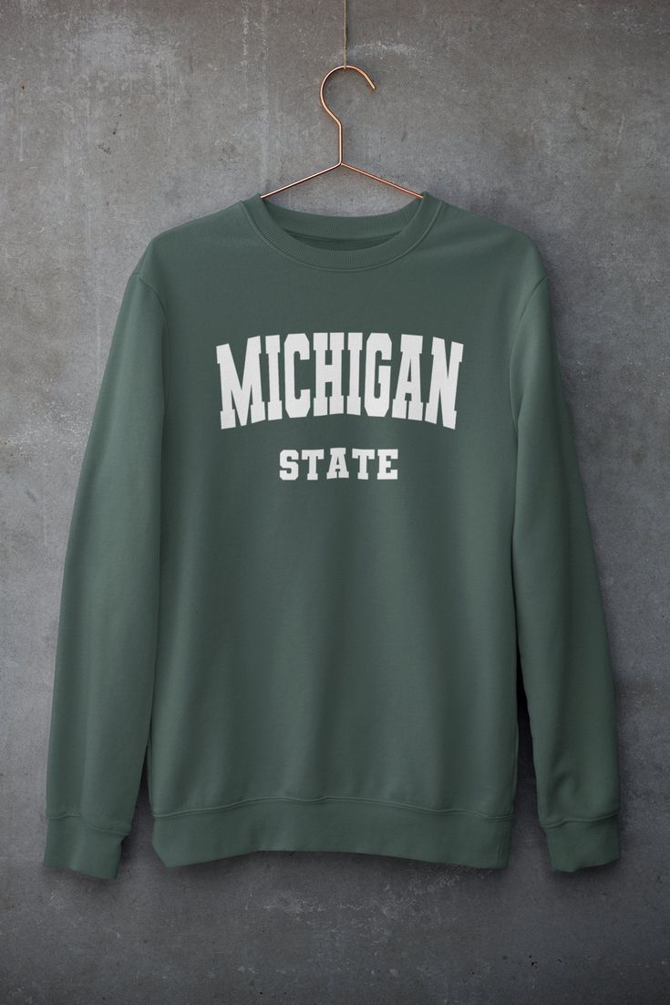 Looking for Michigan State merch? Something for Spartans football season? This Unisex college-style crew neck sweatshirt is sure to bring a smile to faces. The perfect gift for girlfriends, sisters, family and friends alike! - All sizes are Unisex - Printed in USA - 50% cotton, 50% polyester - Pre-shrunk - 1x1 athletic rib-knit collar with spandex - Air-jet spun yarn with a soft feel and reduced pilling - Double-needle stitched collar, shoulders, armholes, cuffs, and hem - Quarter-turned to avoi Packers Sweatshirt, Perfect Gift For Girlfriend, College Sweatshirt, Pitch Perfect, Savannah Georgia, Custom Sweatshirts, College Fashion, Asheville, Vintage Sweatshirt