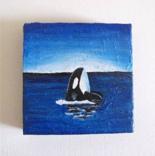 an orca in the ocean painted on a tile