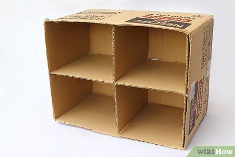 an open cardboard box with four compartments on the front and one section closed to show what's inside