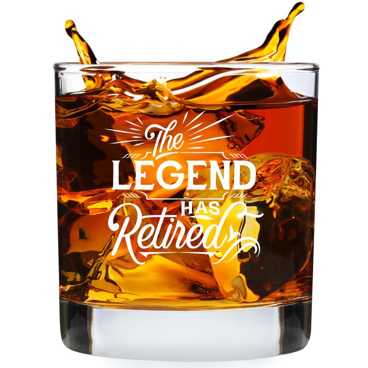 the legend has retired whiskey glass with ice cubes in it on a white background