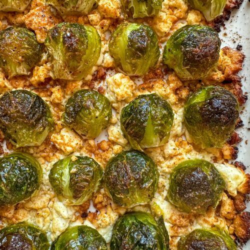 a square pizza topped with brussel sprouts and cheese