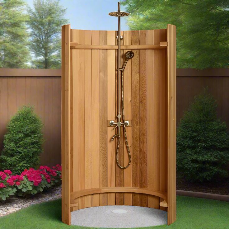 a wooden shower stall in the middle of a yard with flowers and trees behind it