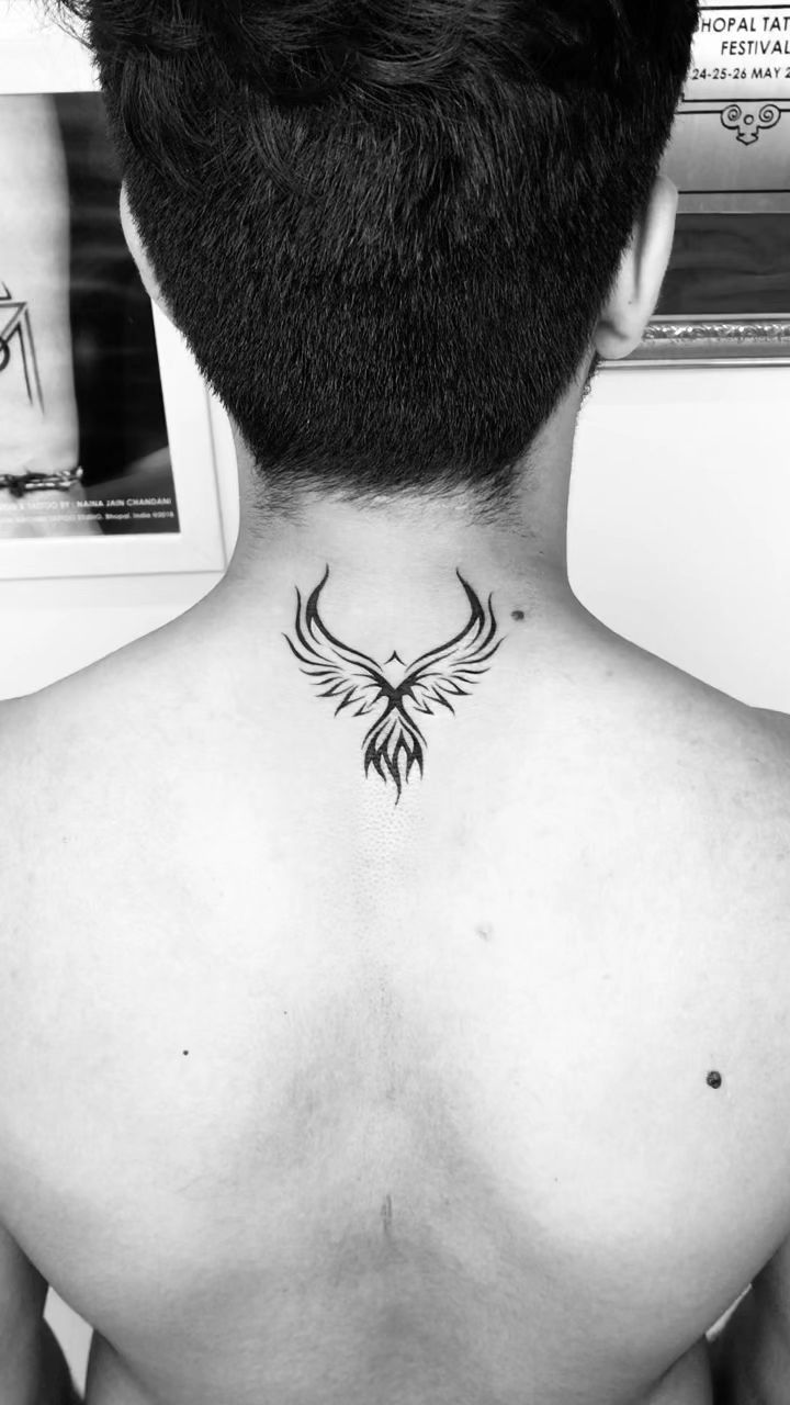 If you're looking for a unique and memorable way to show your support for your favorite team, a back tattoo is the perfect way to do it. From sports logos to traditional images of birds and flowers, there's a back tattoo design that's perfect for you. Back Of Neck Tattoo Men, Phoenix Tattoo Men, Arm Women, Tato Phoenix, Phoenix Tattoo For Men, Small Phoenix Tattoos, Bts Tattoo, Phoenix Bird Tattoos, Small Back Tattoos