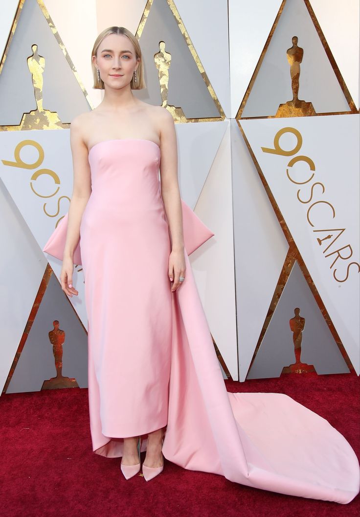 a woman in a pink dress on the oscars red carpet