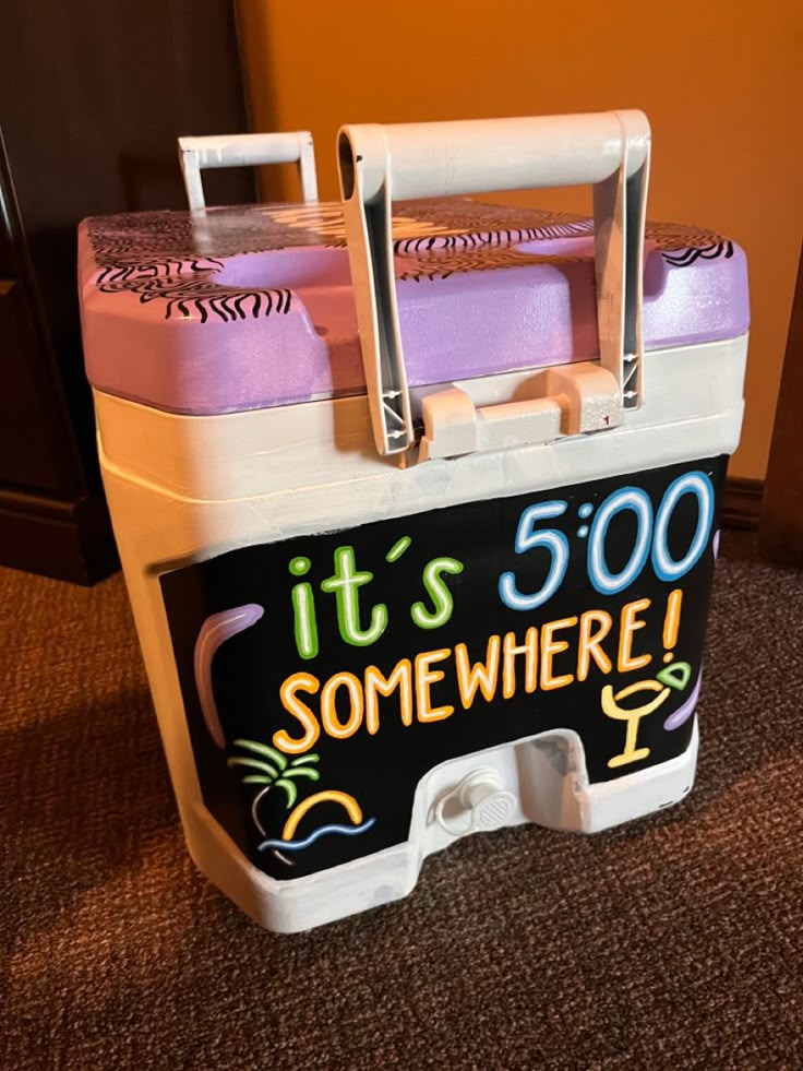 a cooler with it's 500 somewhere written on the front and bottom lid, sitting on carpeted floor