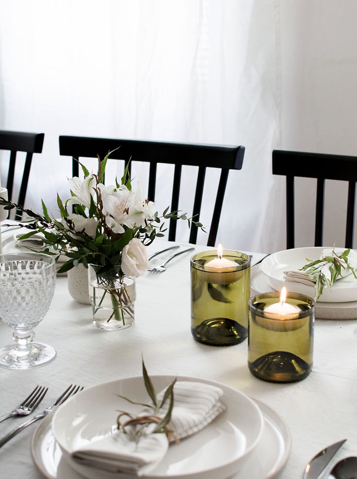 the table is set with candles and plates