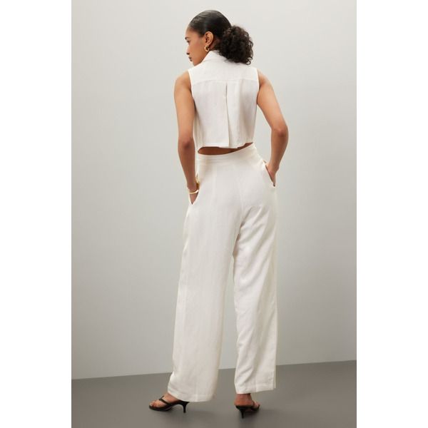 White (Main 85% Viscose, 15% Linen. Lining 100% Viscose). Jumpsuit. Sleeveless. Collared. Front button closure. See size & fit notes for length and measurements. 30" inseam. 13" rise. 8" leg opening. Imported. Sleeveless Fitted Spring Pantsuit, Fitted Sleeveless Spring Pantsuit, Fitted Sleeveless Pantsuit For Spring, Tailored Sleeveless Spring Pantsuit, Sleeveless Summer Pantsuit For Formal Occasions, Sleeveless Summer Formal Pantsuit, Sleeveless Pantsuit For Summer Formal Occasions, Sleeveless Pantsuit For Formal Summer Events, Sleeveless Formal Summer Pantsuit