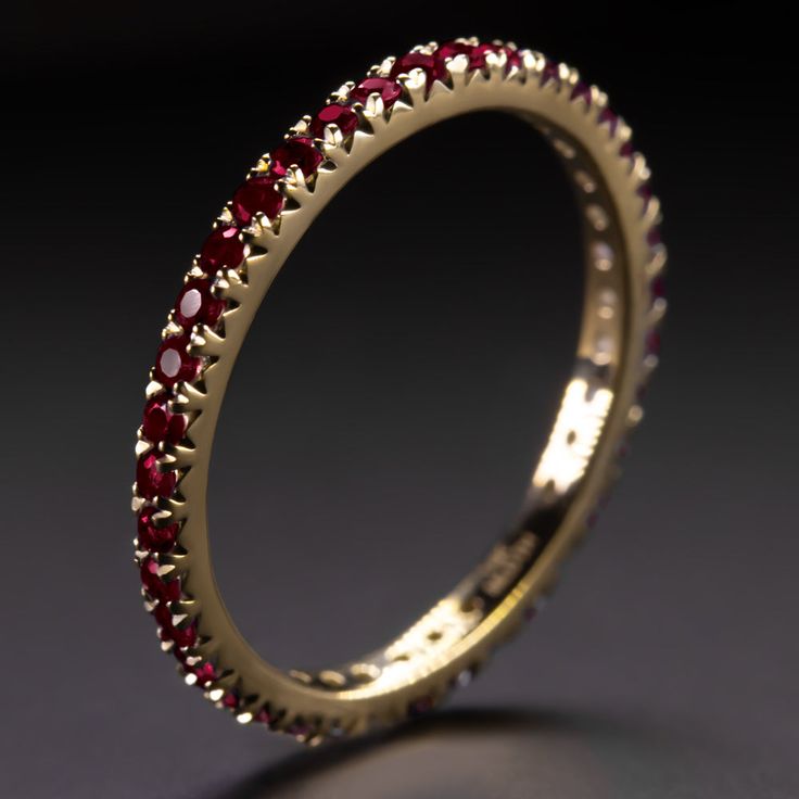 Why we love it:This ruby band has a classic design with rich red rubies continuing all the way around the band! It is a great choice for a wedding band or a stand alone piece.Highlights:- 0.70 carat of natural rubies- Full eternity design- Solid 14k yellow gold settingDimensions:The ring measures 1.9mm across (north south) and 2.0mm from finger to topSizing:As an eternity ring, this can’t be easily resized. It is only available in size 6.Additional Notes:This is part of a larger collection of na Luxury Red Ruby Half Eternity Ring, Elegant Red Stackable Eternity Band, Luxury Stackable Ruby Ring For Wedding, Elegant Ruby Eternity Band In Yellow Gold, Elegant Yellow Gold Ruby Eternity Band, Elegant Red Eternity Band For Anniversary, Elegant Red Round Eternity Band, Elegant Red Ruby Eternity Band, Elegant Red Round Cut Eternity Band