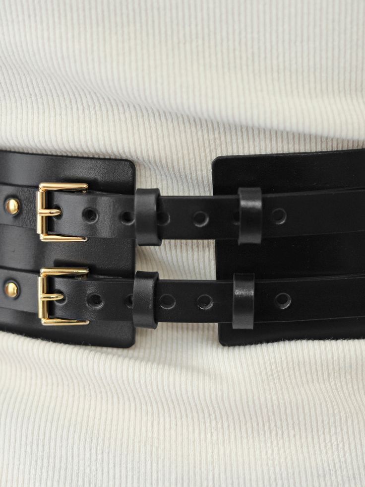 Made from smooth italian leather, this wide belt will help you complete your style. With elegant hardware at the front, the belt can be worn with a dress or with a shirt for a chic outfit. Belt width: 7 cm Adjustable using the back buckles Designed to be fitted on the waist Luxury Elegant Belt With Leather Lining, Black Leather Waist Belt, Luxury Leather Corset Belt, Black Leather Belt With Gold-tone Hardware, Luxury Leather Belts With Gold-tone Hardware, Wide Leather Belt, Silver Lights, Gold Light, Brown Silver