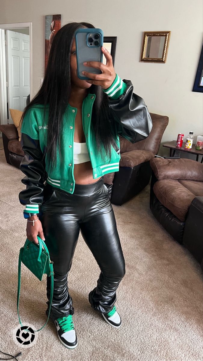 Girl standing in mirror wearing a green, black, and white cropped jacket, white crop top, and black stacked faux leather pants. She’s holding a green purse. Has on Nike Jordan 1 Lucky Green sneakers Jordan 1 Reverse Laney Outfit, Jordan Outfit Ideas Women, Air Jordan 1 Outfit Women Baddie, Jordan Outfit Women Baddie, Style Jordan 1 Women Outfit, Retro Jordan Outfits Womens, Jeans And Jordans Outfit Women, Women Jordan 1 Fashion Styles, Dress With Jordan 1 Outfit