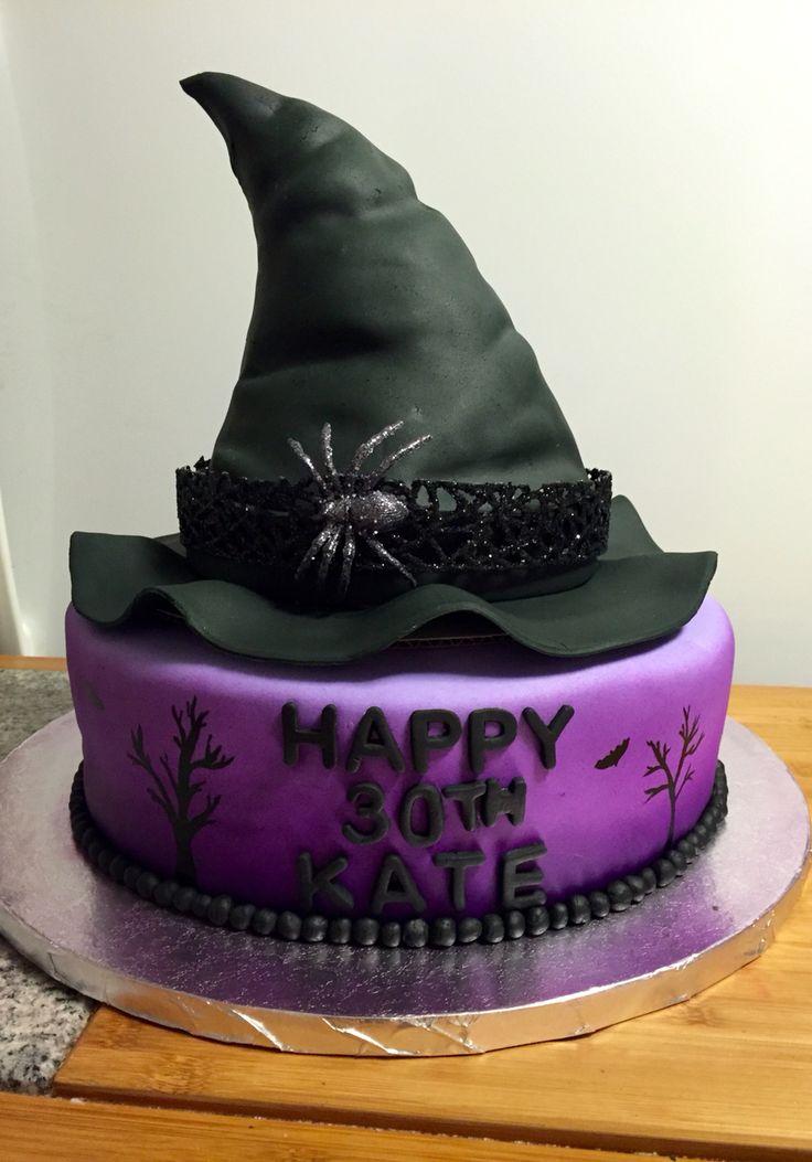 a purple and black cake with a witches hat on top