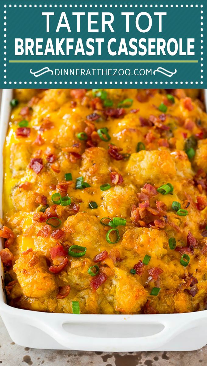 tater tot breakfast casserole in a white dish with green onions and bacon