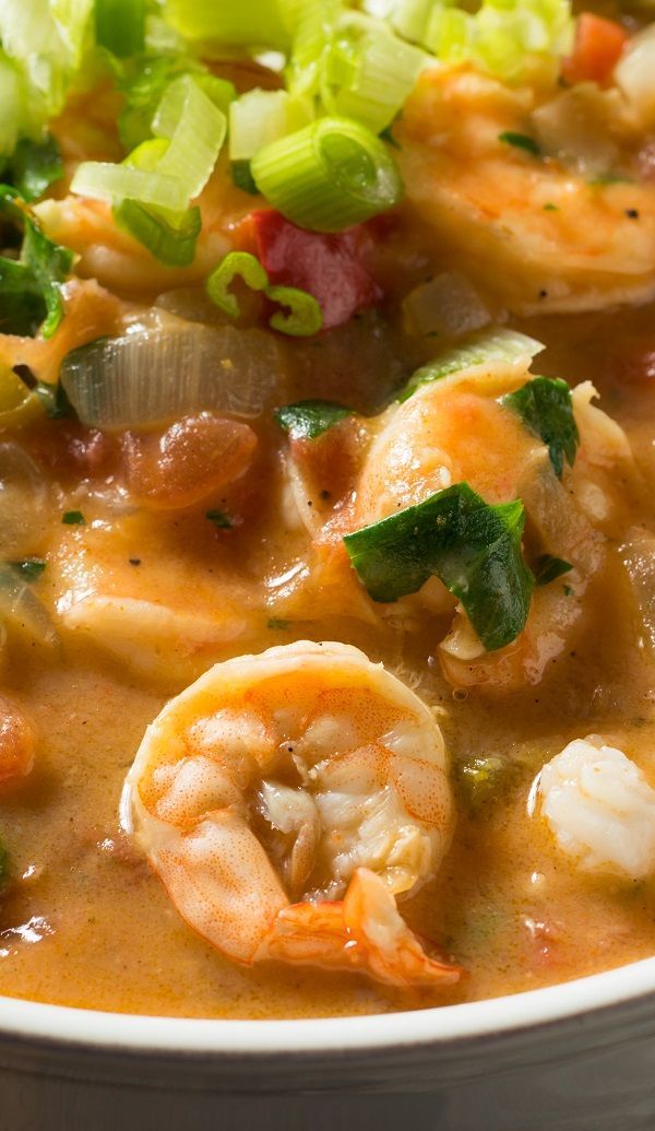 a white bowl filled with shrimp and vegetable soup