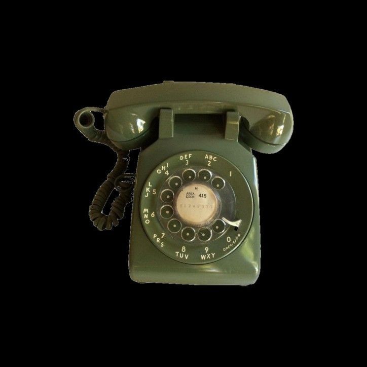 an old fashioned green phone on a black background