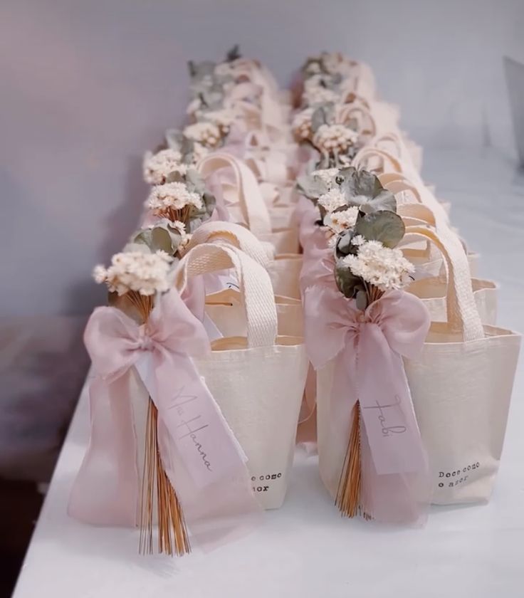 several bags with flowers on them are lined up