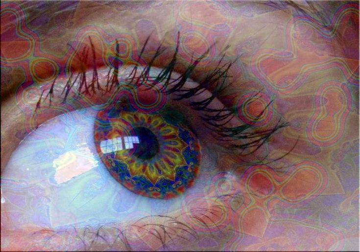 an eye is shown with colorful swirls on the iris and around it's center