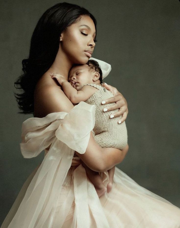 a woman holding a baby in her arms