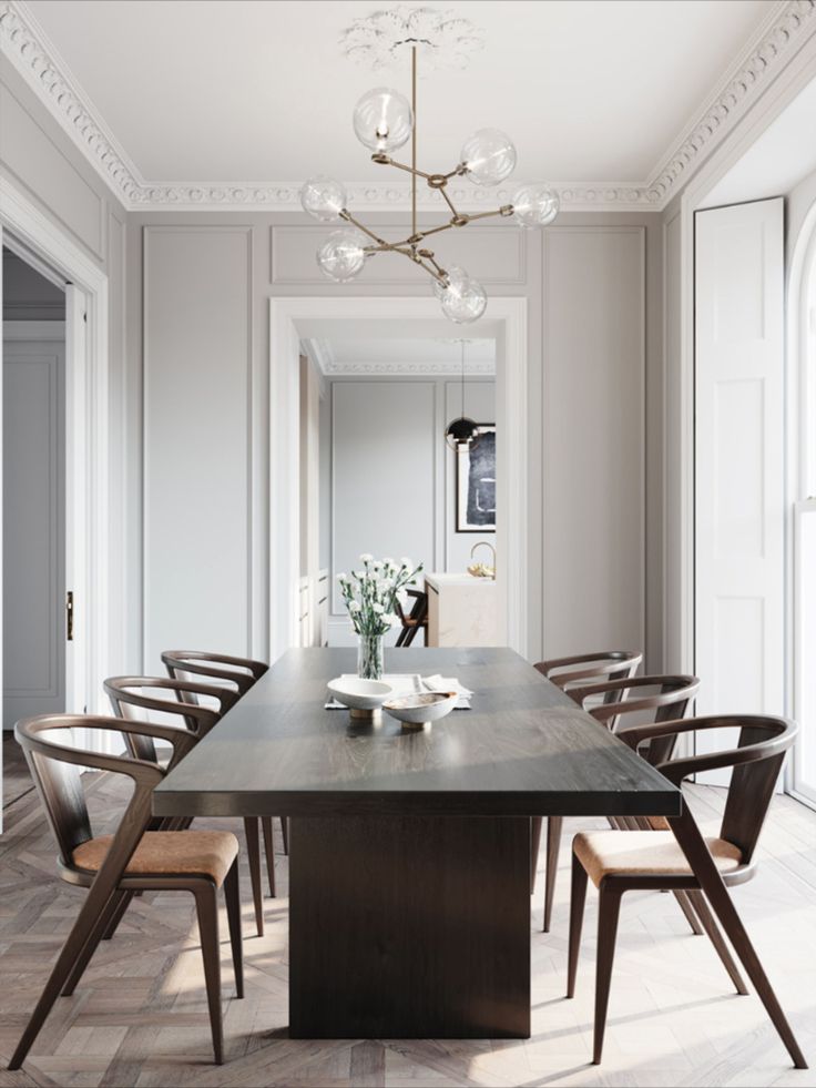 an elegant dining room with white walls and wood flooring is pictured in this image