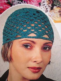 a woman wearing a green crocheted hat with holes on the front and side