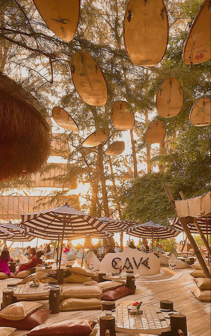 an outdoor seating area with umbrellas and chairs