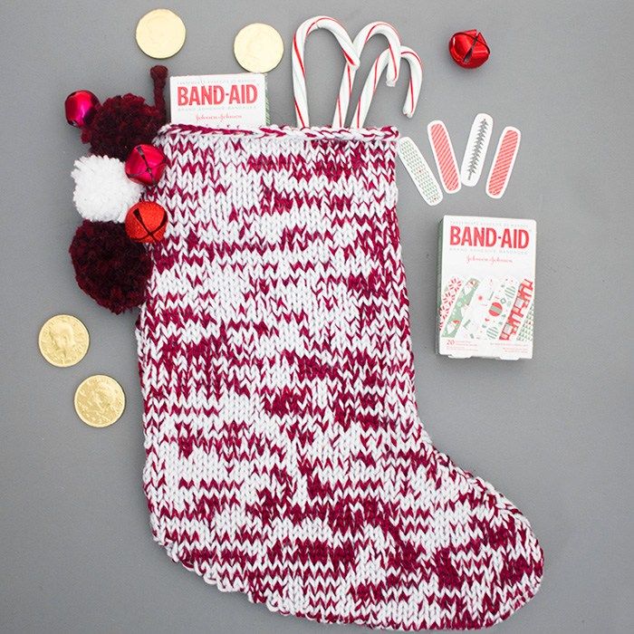 a christmas stocking, candy canes and other decorations are laid out on a table